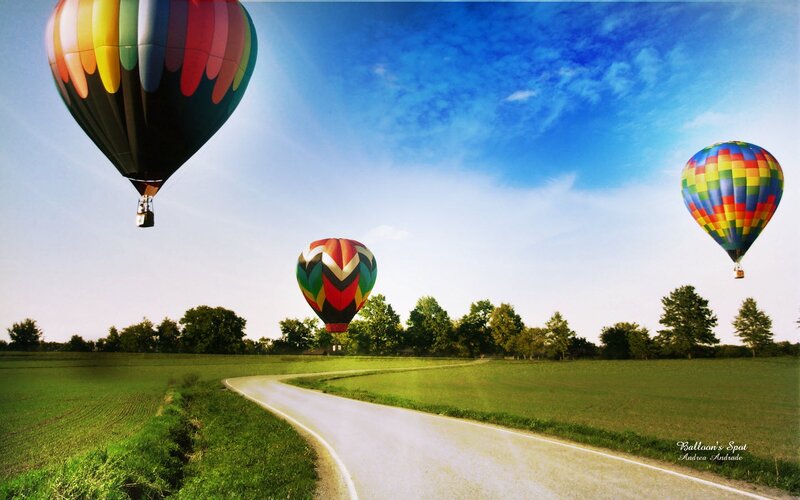 Hot air balloons over a country road