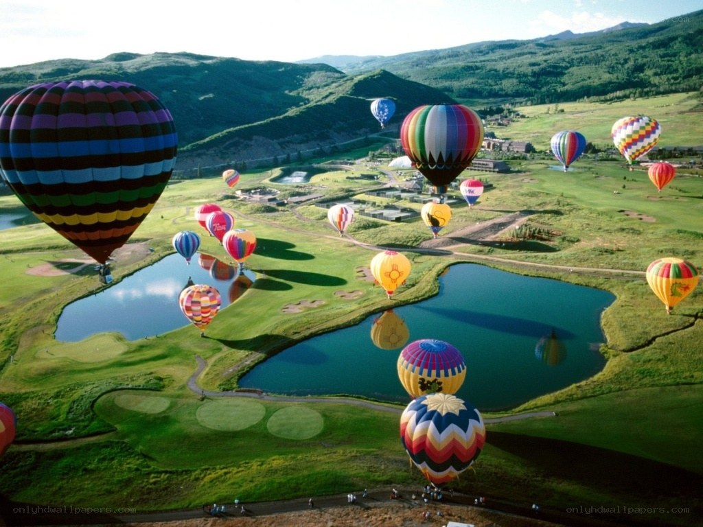 Hot air balloons over a golf course