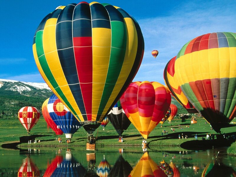Hot air balloons over a lake