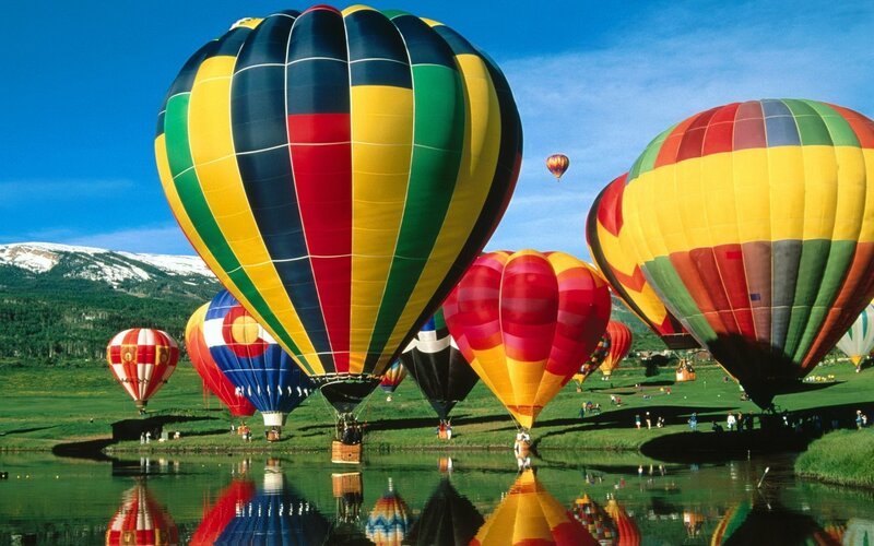 Hot air balloons over a lake