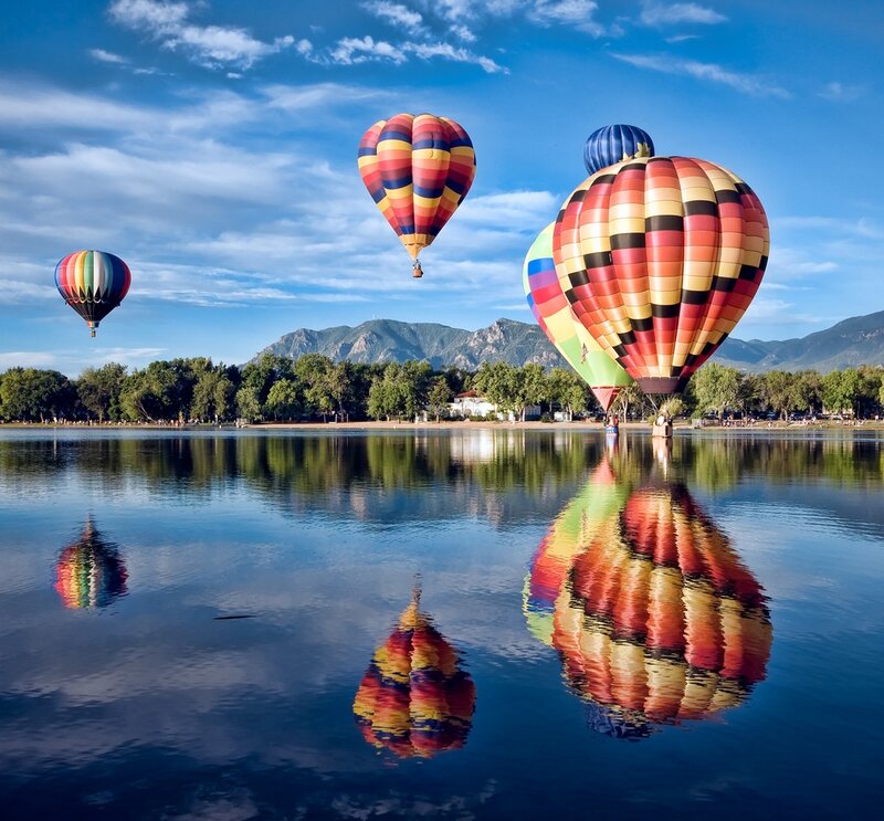 Hot air balloons over a lake