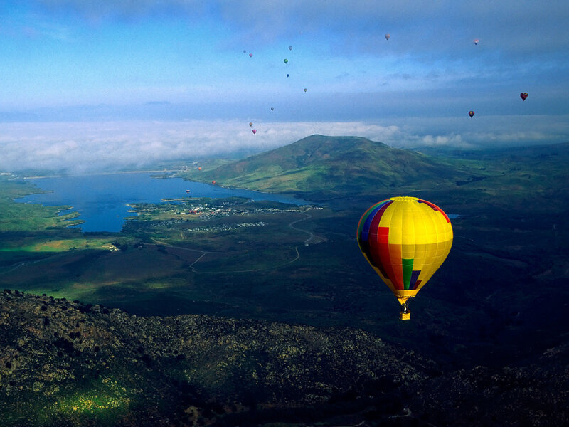 Hot air balloons over a lake