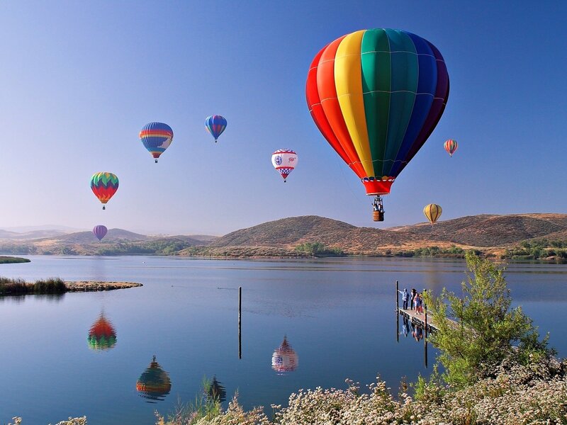 Hot air balloons over a lake
