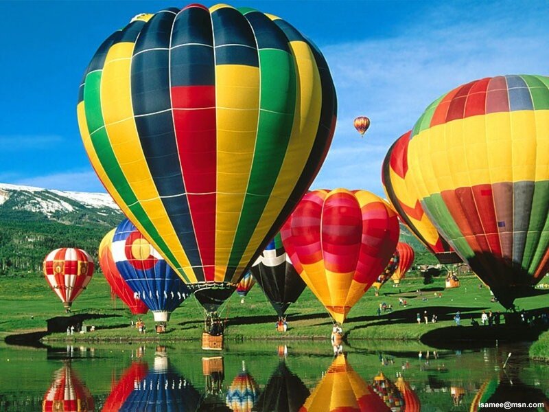 Hot air balloons over a lake