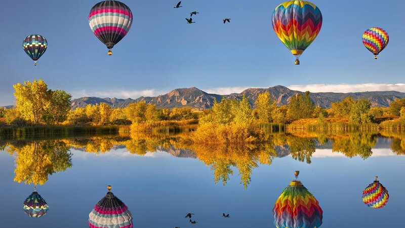 Hot air balloons over a lake