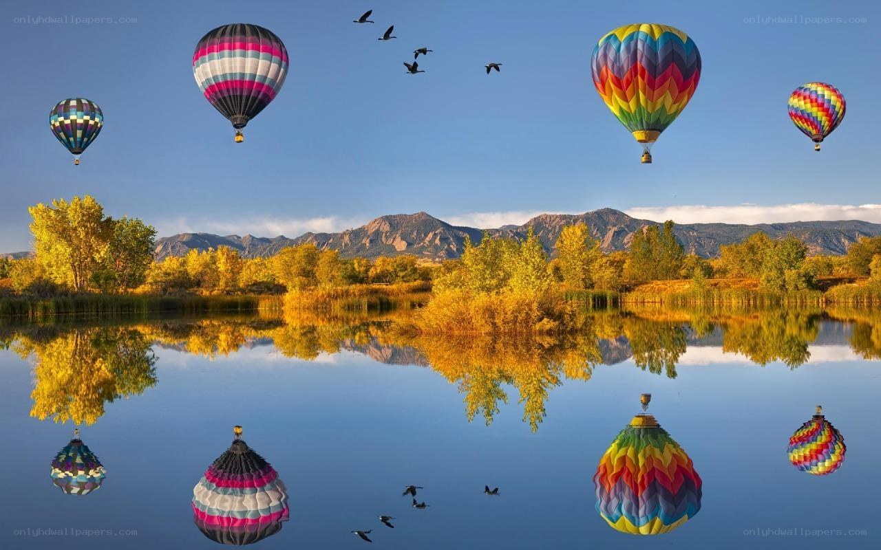 Hot air balloons over a lake