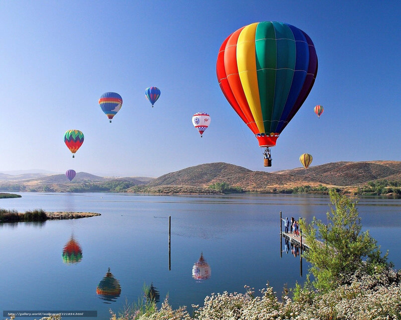 Hot air balloons over a lake
