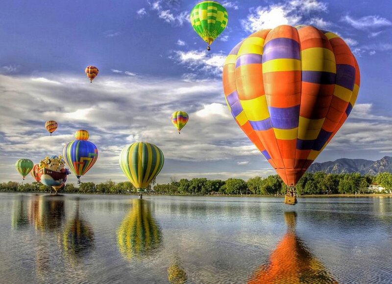 Hot air balloons over a lake