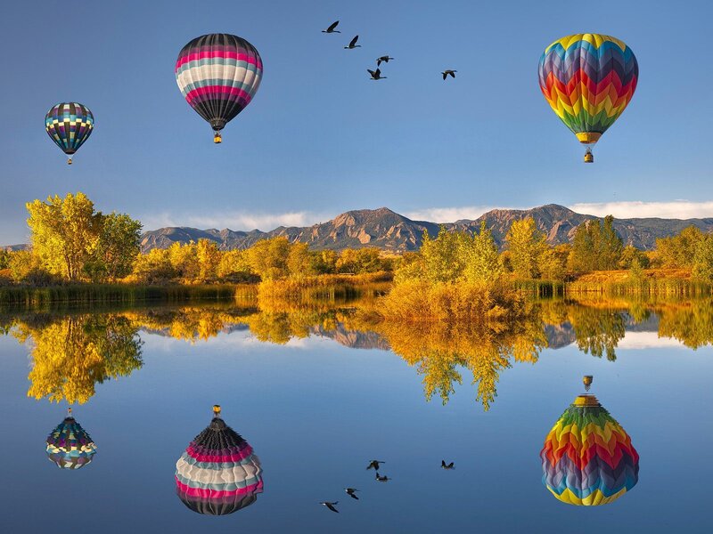 Hot air balloons over a lake