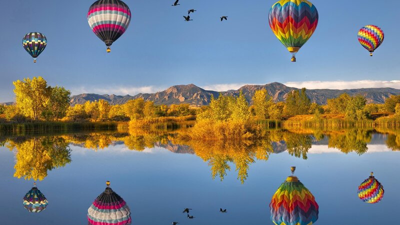 Hot air balloons over a lake