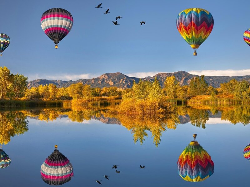 Hot air balloons over a lake