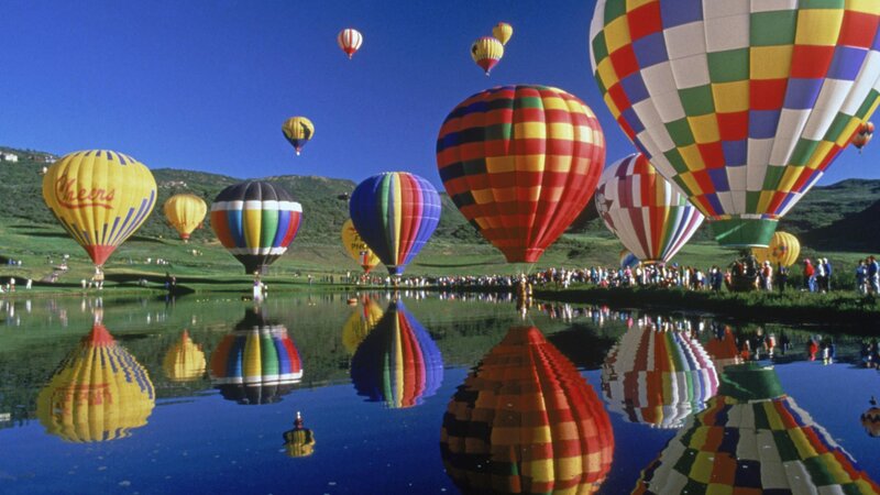 Hot air balloons over a lake