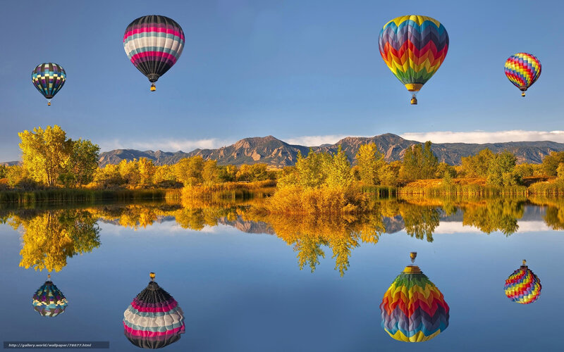 Hot air balloons over a lake
