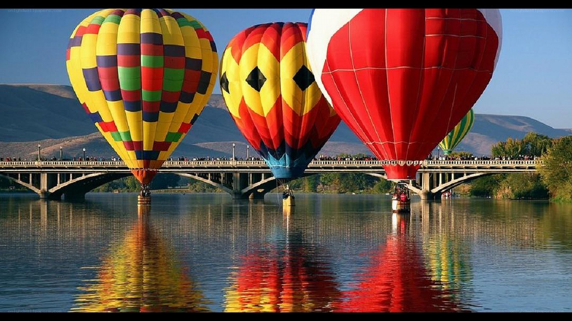Hot air balloons over a river