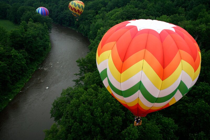 Hot air balloons over a river