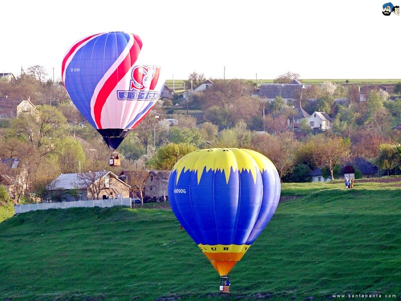 Hot air balloons over a village