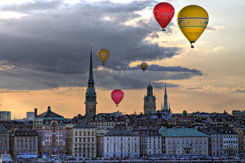 Hot air balloons over city skyline