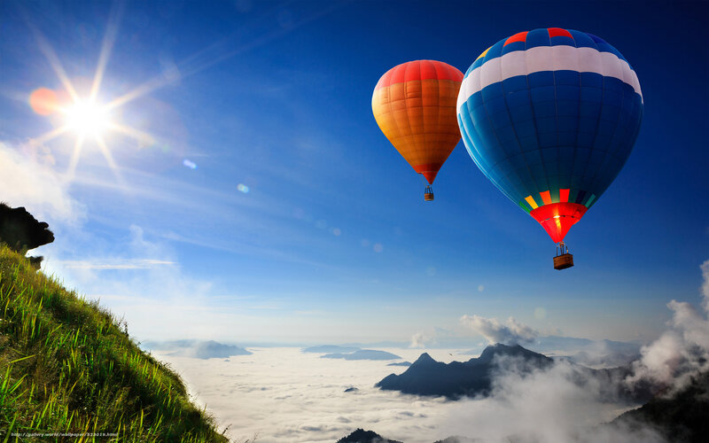 Hot air balloons over clouds