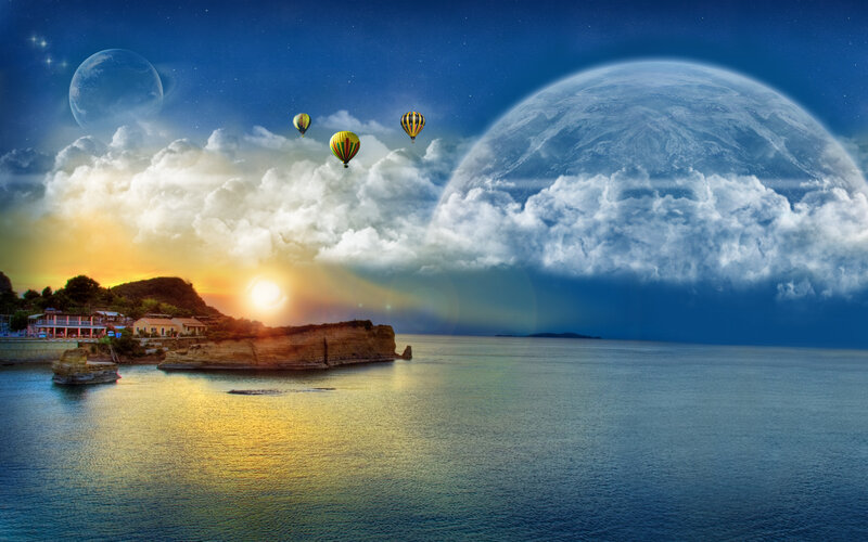 Hot air balloons over coastal town
