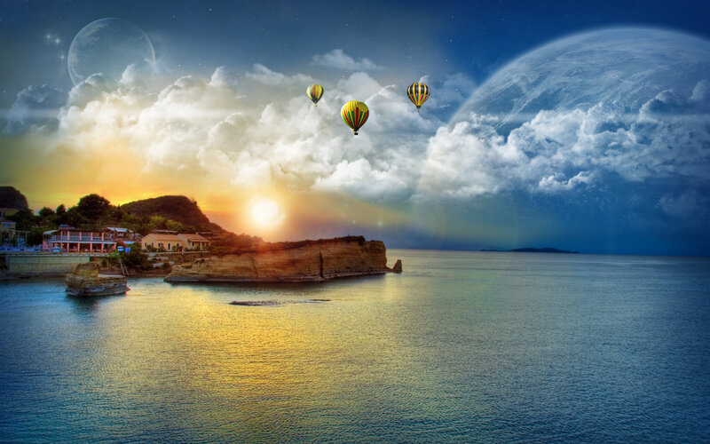 Hot air balloons over coastal town