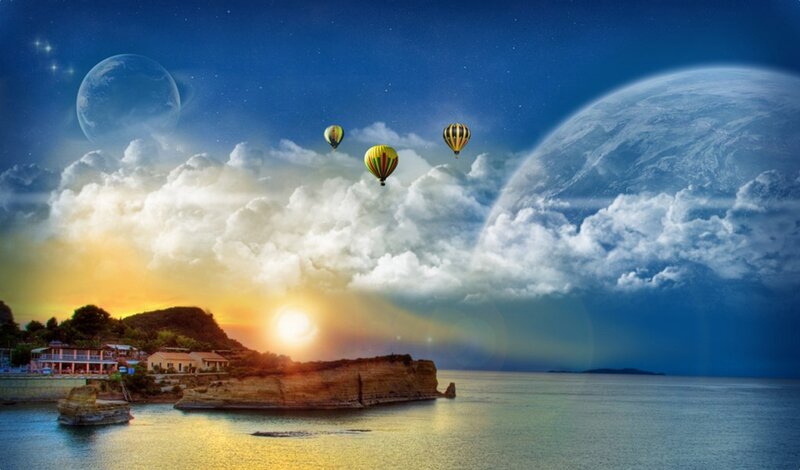 Hot air balloons over coastal town