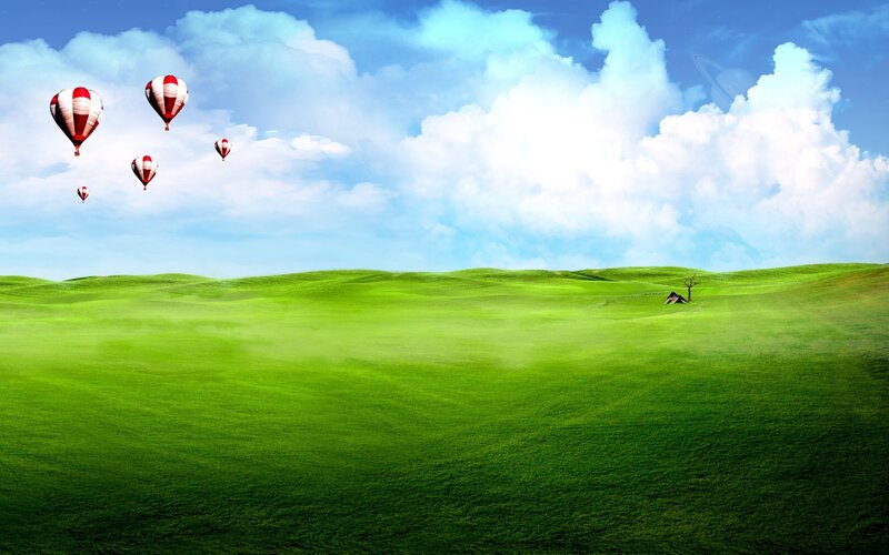 Hot air balloons over green hills