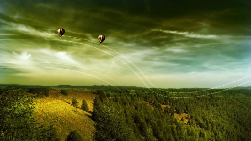 Hot air balloons over green hills