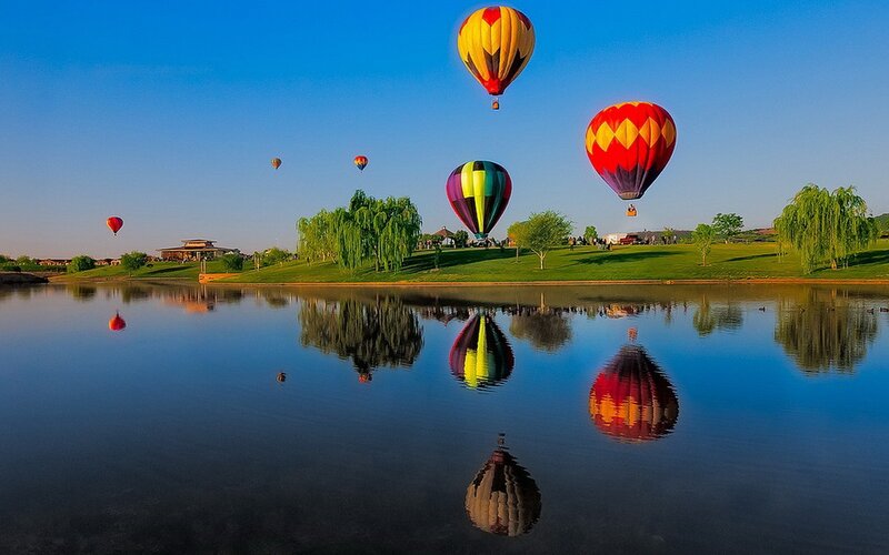 Hot Air Balloons over Lake — Blue, Serene, Morning, Photograph, Trees, Grass