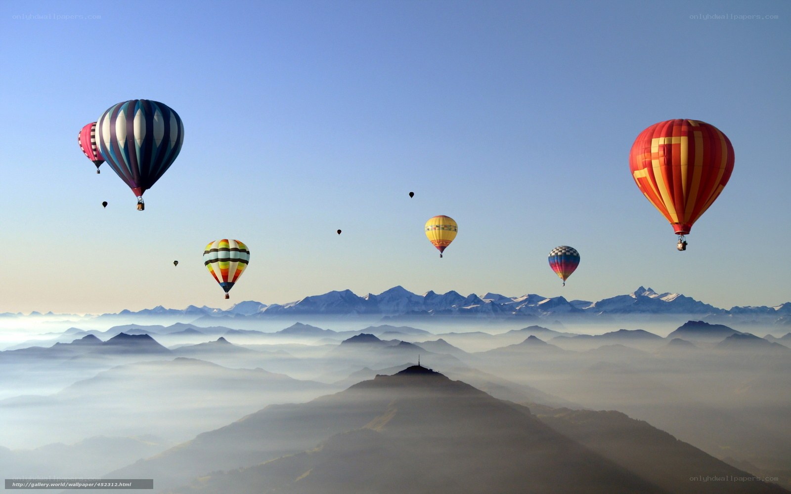 Hot air balloons over mountain fog