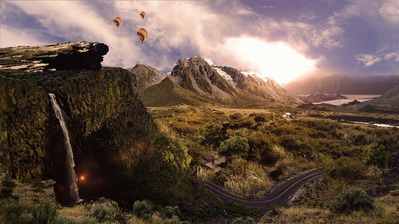Hot air balloons over mountain landscape
