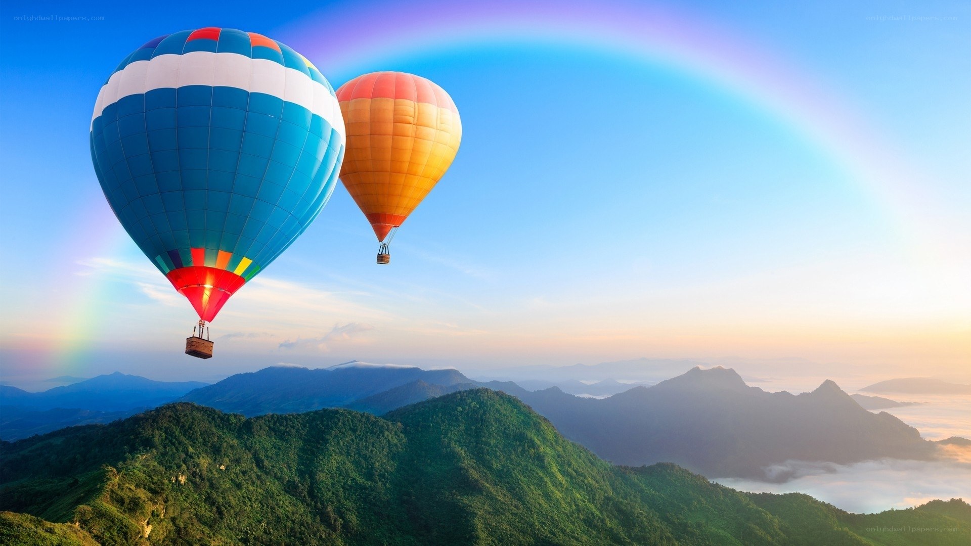 Hot air balloons over mountains