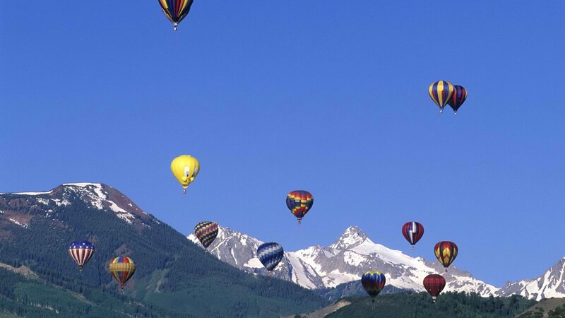 Hot air balloons over mountains