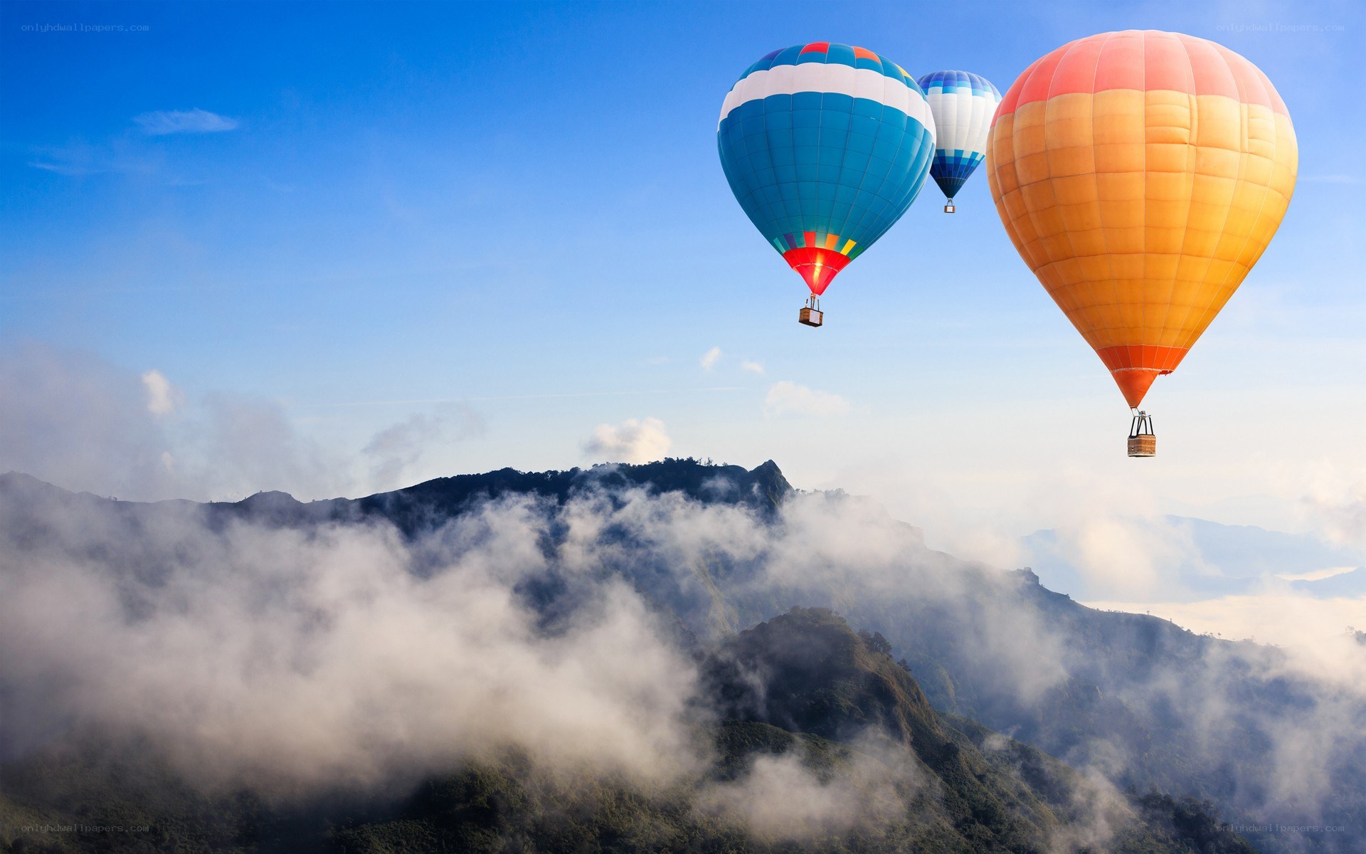 Hot air balloons over mountains