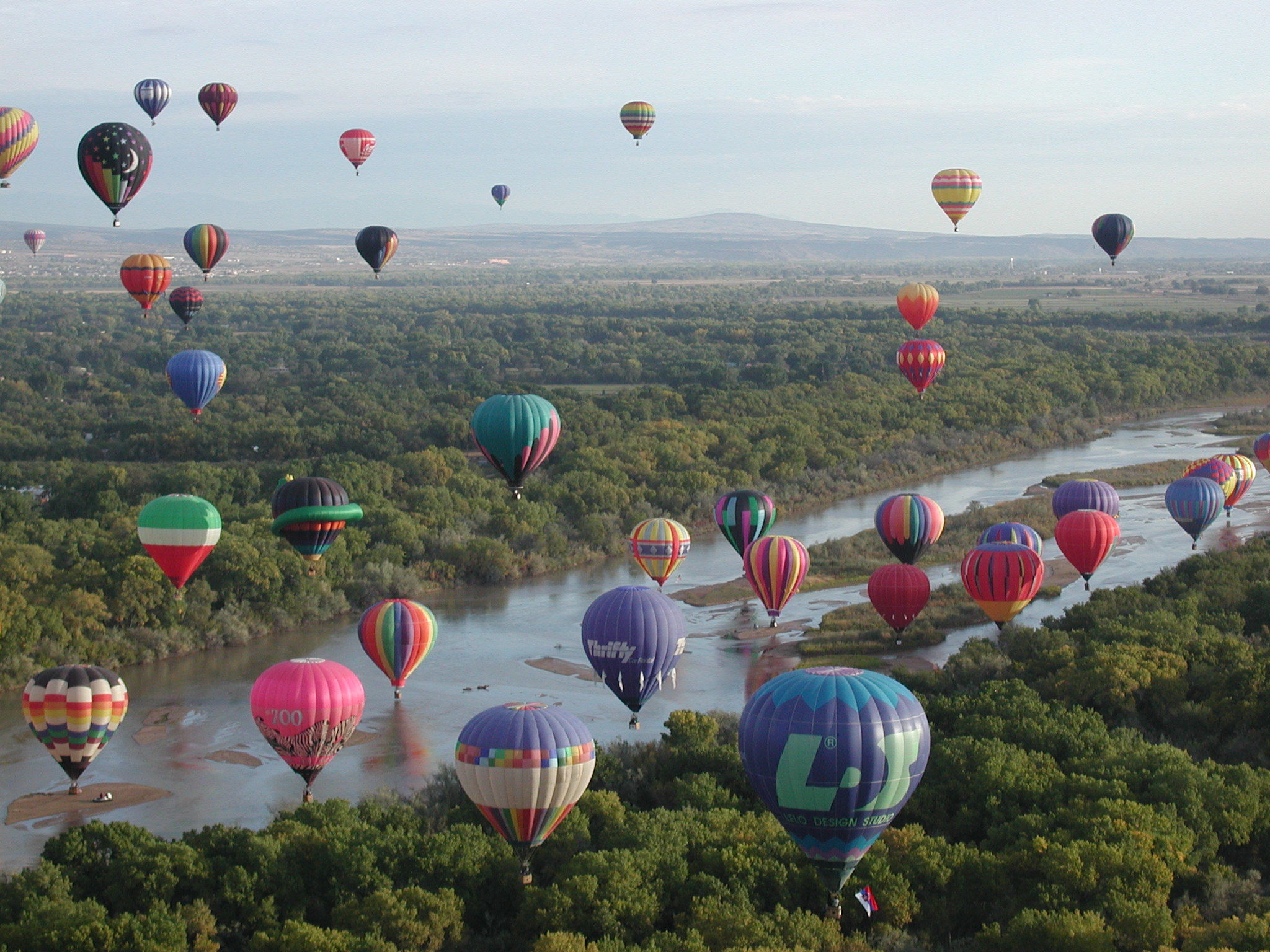 Hot air balloons over river