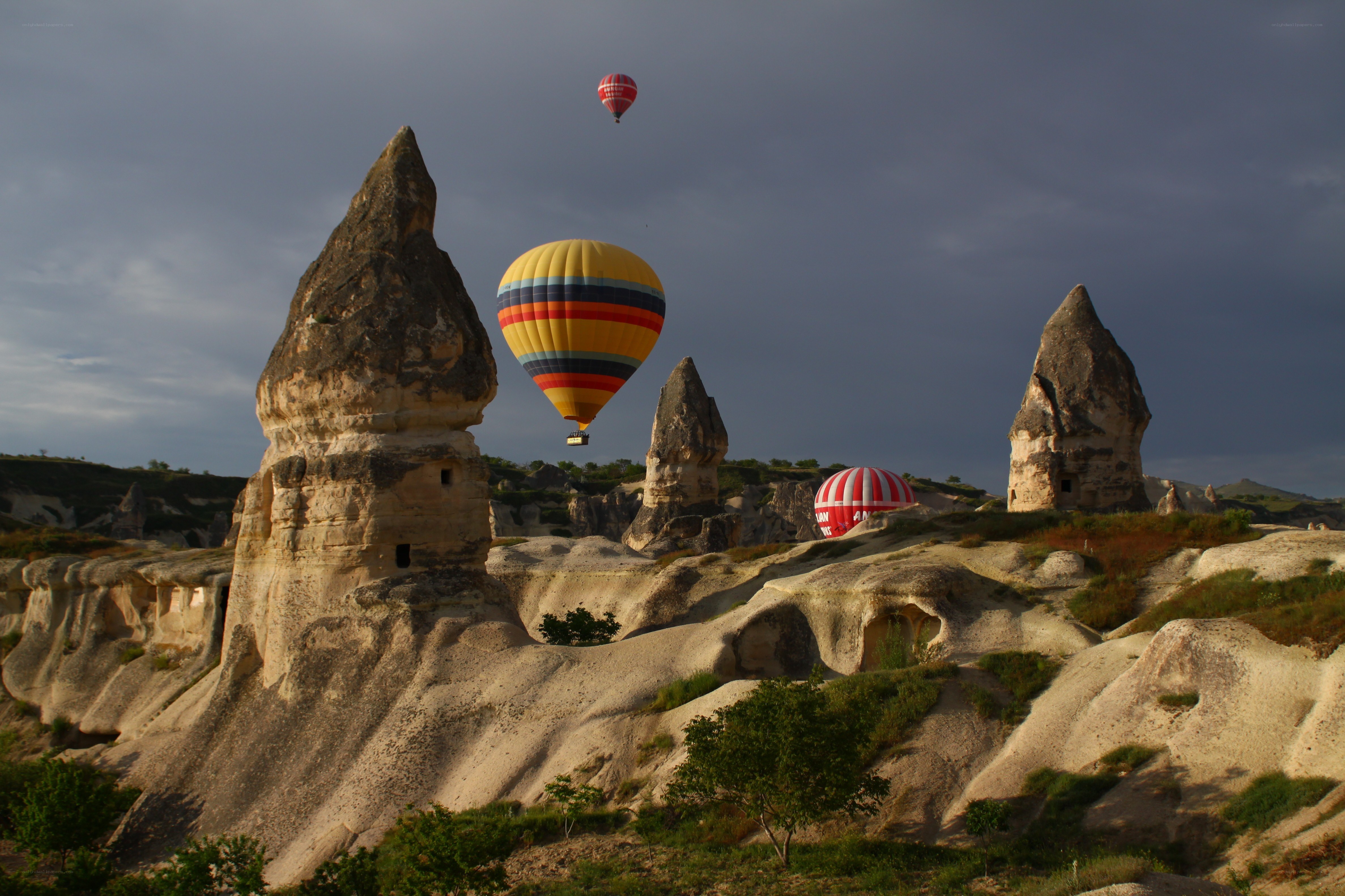 Hot air balloons over rock formations