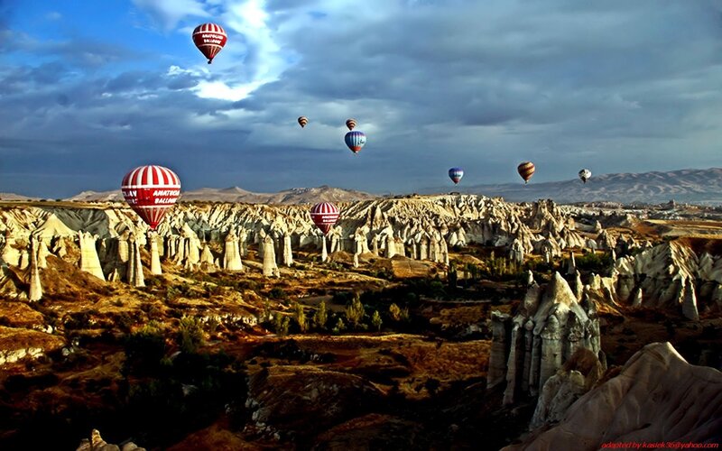 Hot Air Balloons over Rock Formations — Blue, Dramatic, Morning, Photograph, Rock Formations, Sky