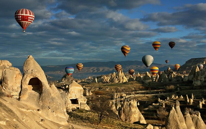 Hot Air Balloons over Rock Formations — Blue, Dramatic, Morning