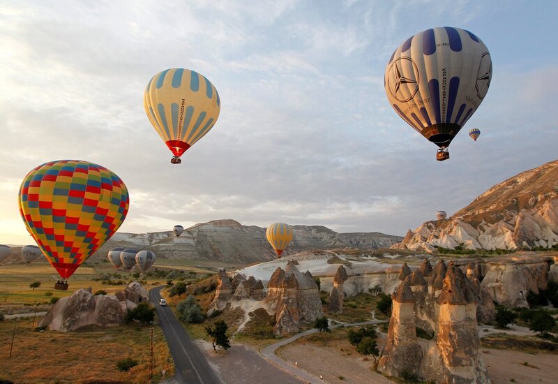 Hot Air Balloons over Rock Formations — Blue, Serene, Morning, Photograph, Rock Formations
