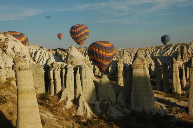 Hot air balloons over rock formations