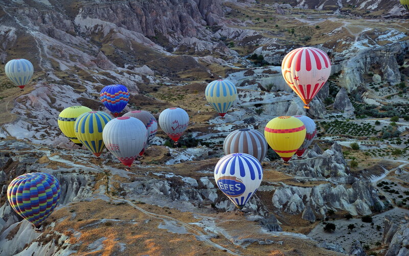 Hot Air Balloons over Rock Formations — White
