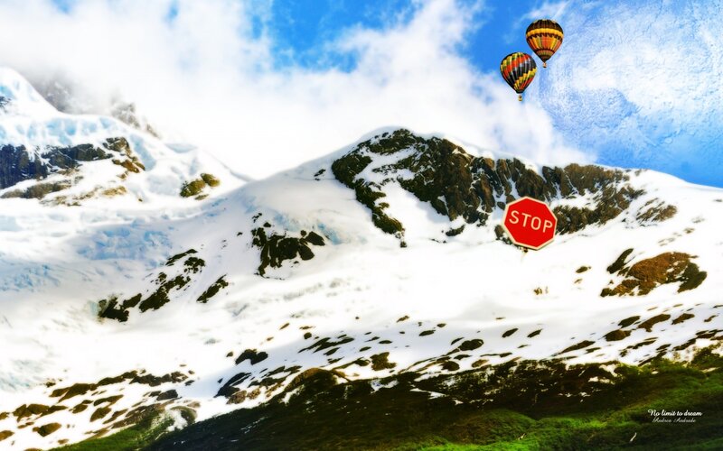 Hot air balloons over snowy mountains