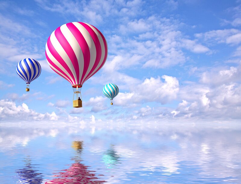 Hot air balloons over water