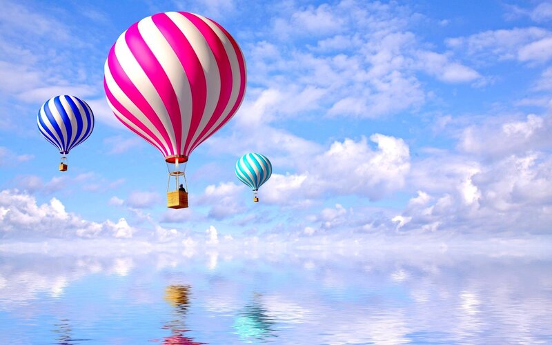 Hot air balloons over water
