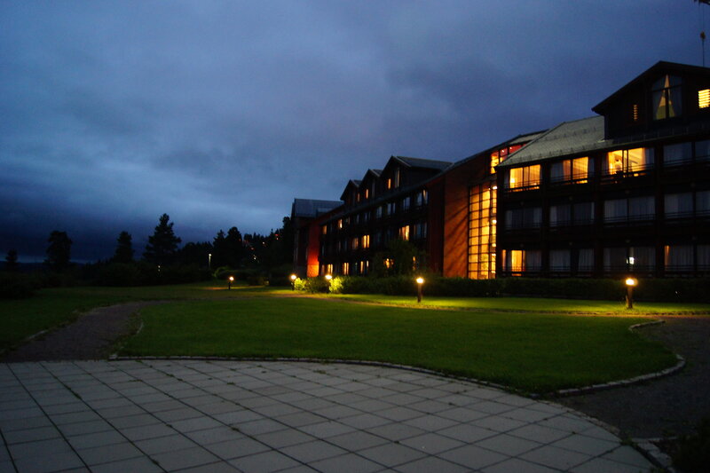 hotel at dusk with lit windows