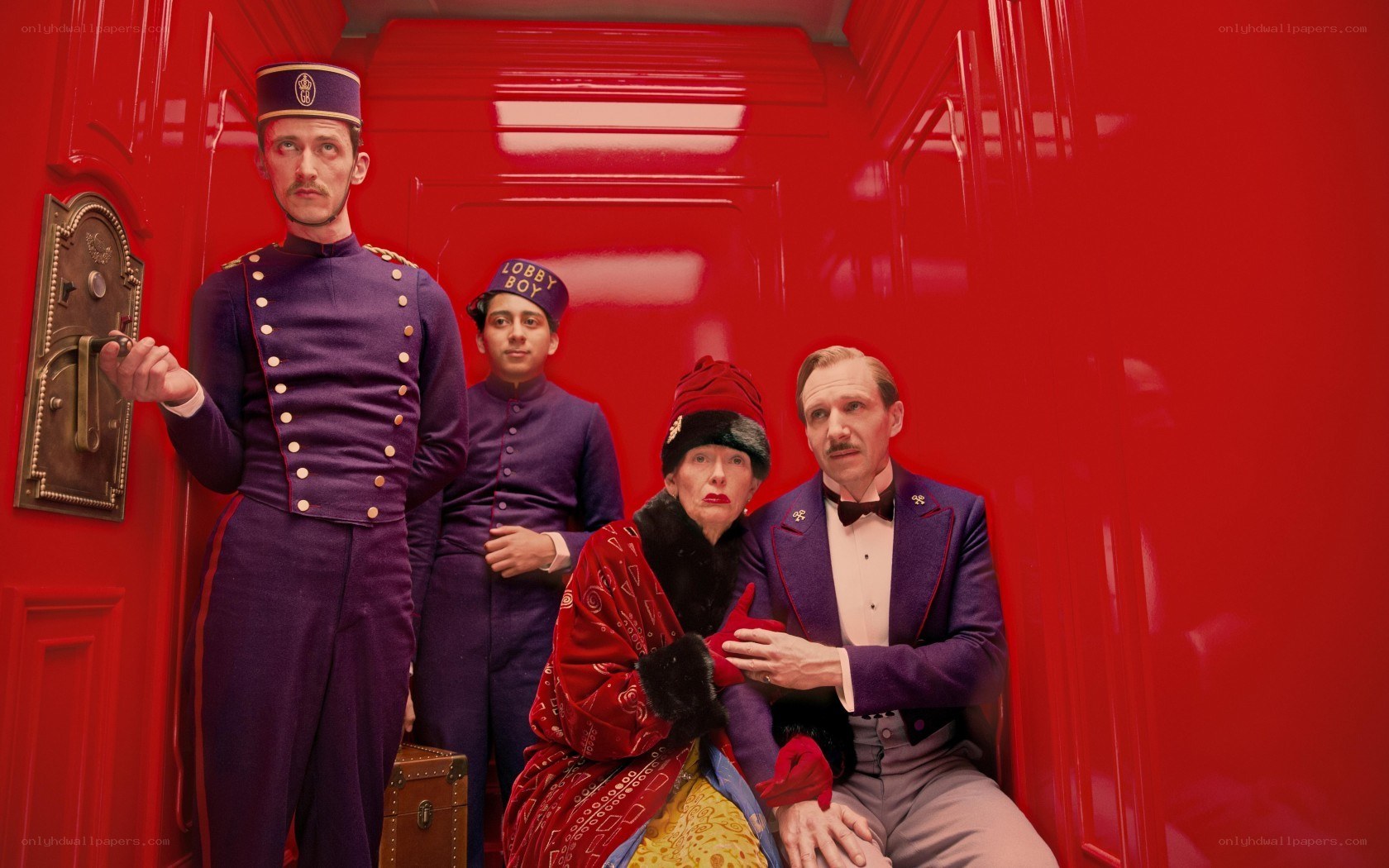 Hotel lobby staff in red elevator