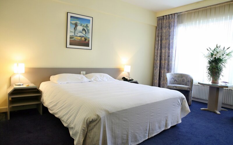 hotel room with bed and artwork