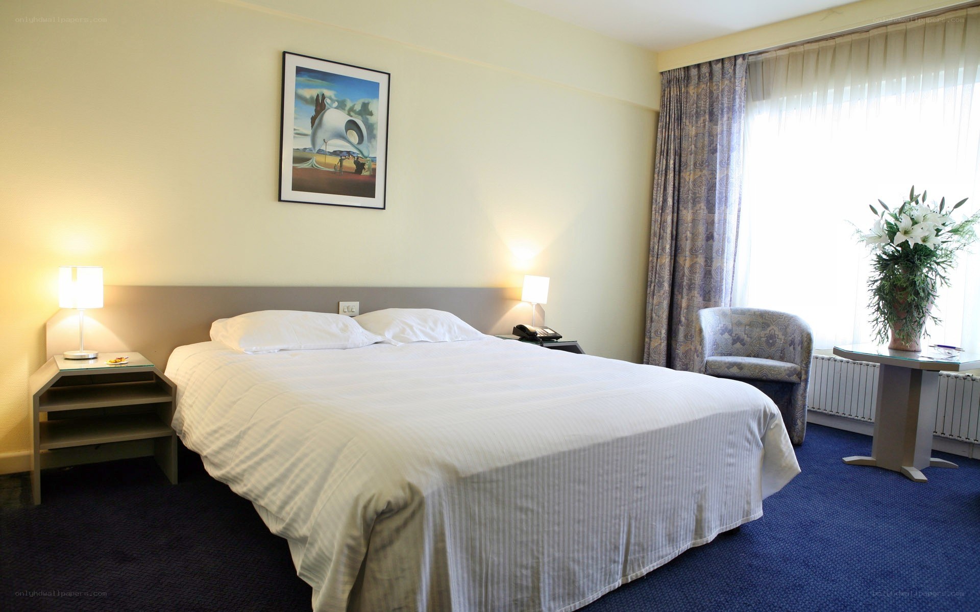 hotel room with bed and artwork