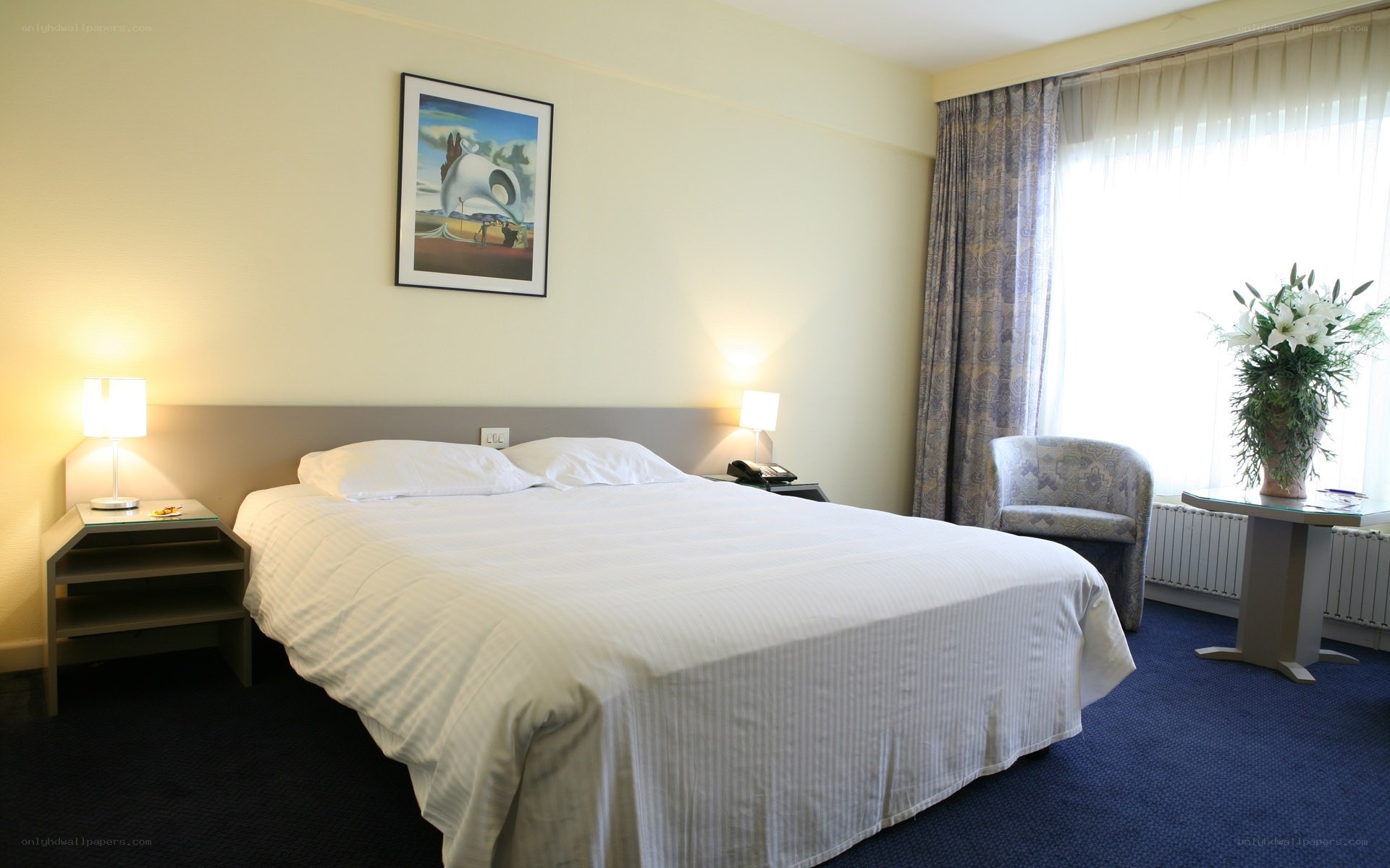 hotel room with bed and artwork