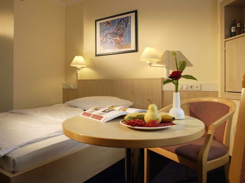 Hotel room with fruit and flowers