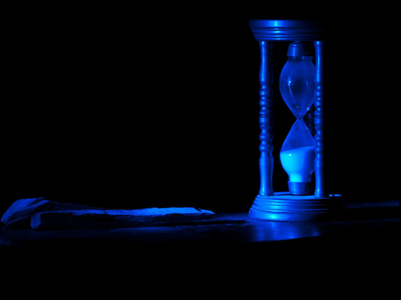 Hourglass on Dark Surface — Blue